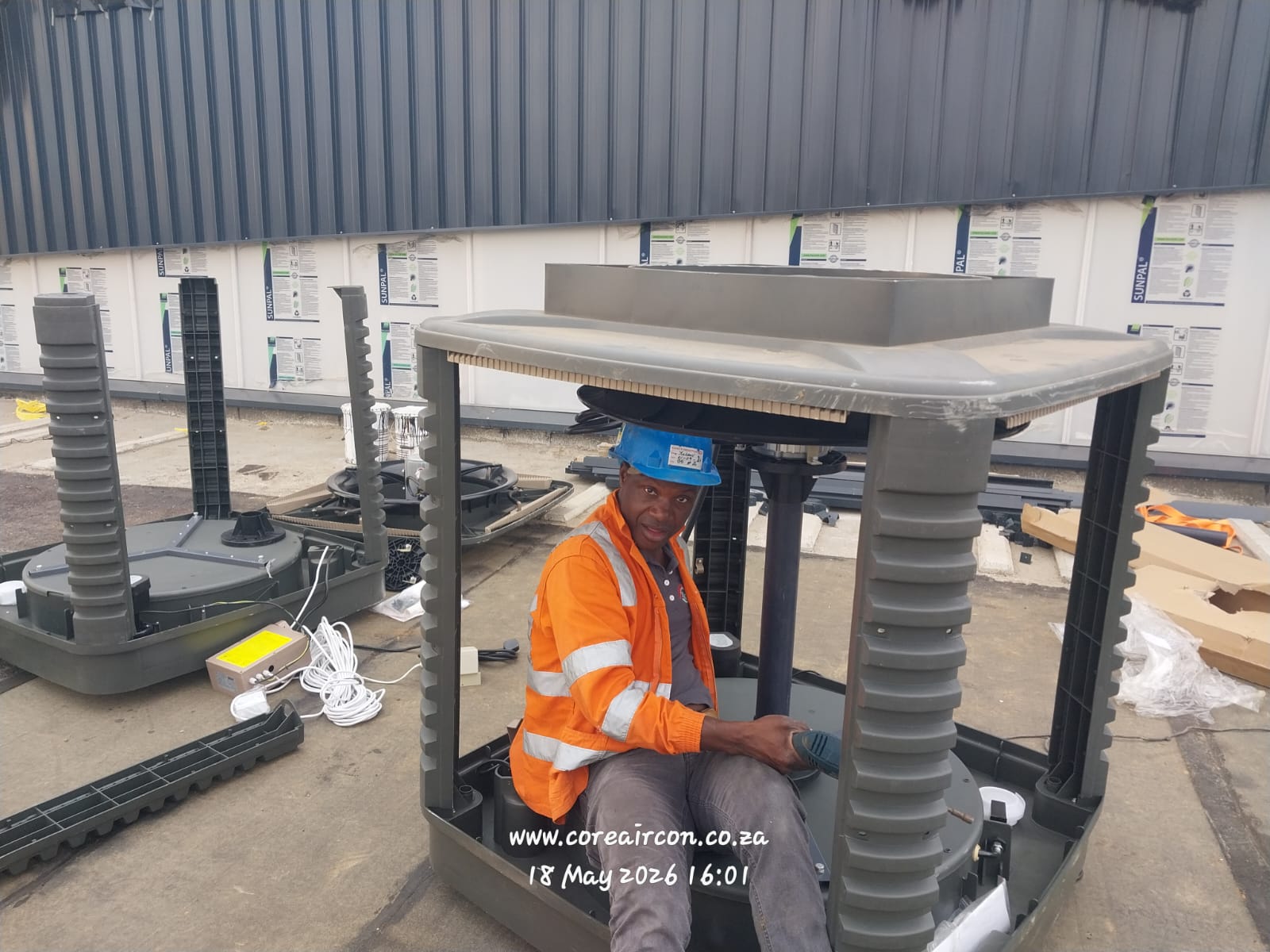 Technician assembling an evaporative cooling unit