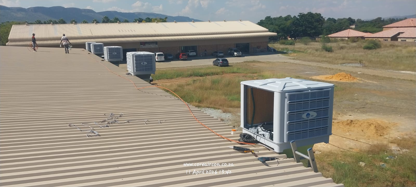 Evaporative cooling units installed along a commercial rooftop