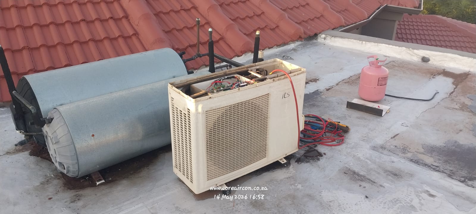 Air conditioner outdoor unit gas regas on a residential roof