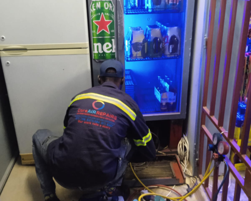 Core Air technician repairing a commercial refrigeration unit